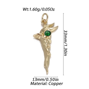 Macro view of gold copper Evil Eye pendant with green bead and dimension measurements