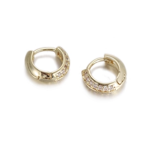Close-up of gold plated huggie earrings with sparkling cubic zirconia pavé stones