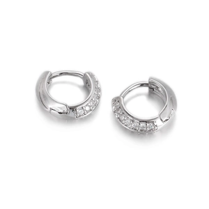 Macro shot of silver huggie earrings with micro-pave cubic zirconia and spring clasp closure