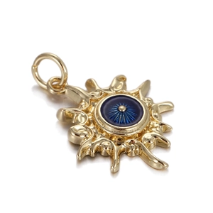 Macro detail of sunburst golden evil eye charm with blue center and high polished finish
