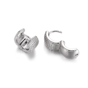 Macro view of silver hoop earrings with pave-set cubic zirconia and hinged closure detail