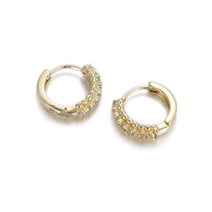 Detail of gold huggie hoop earrings featuring a row of pave-set light purple zircon stones