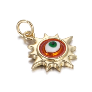 Detail of a gold sun-shaped Evil Eye pendant charm with a vibrant green iris inlay