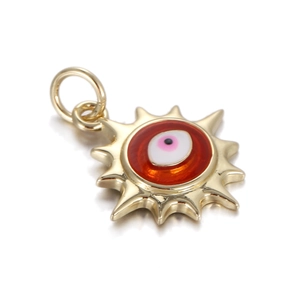 Detailed close-up of golden sun-shaped Evil Eye pendant with red and pink enamel finish