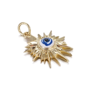 Macro shot of sunburst evil eye pendant in gold finish with blue enamel detail