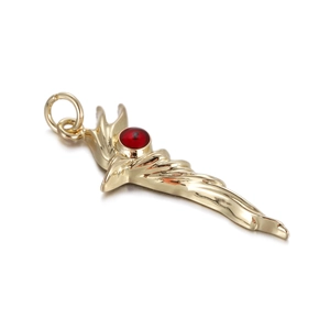 Detailed close-up of golden wing-shaped charm with central red evil eye gem inlay