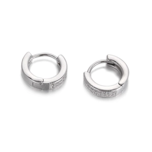 Detail of silver hoop earrings with pavé set cubic zirconia on a white background