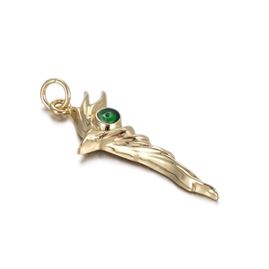Detailed view of a gold-toned swirl pendant with a round green gemstone inlay
