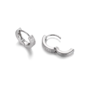 Detailed macro of silver hinged earrings featuring double rows of micro-pave zircons