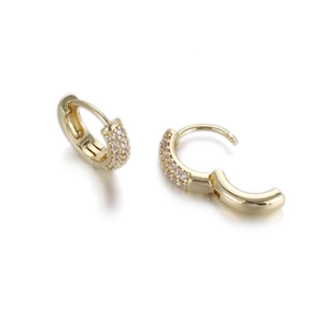 Close-up of golden huggie earrings with multiple rows of sparkling zircon crystals