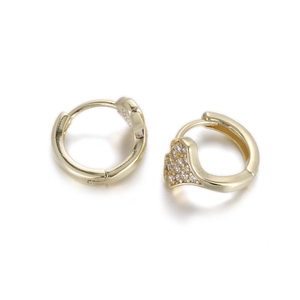 Detail of gold hoop earrings with sparkling zircon heart-shaped accents and clasp closure