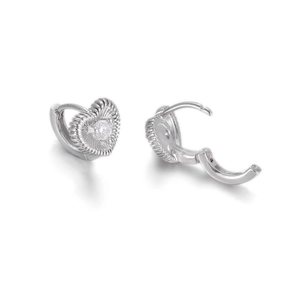 Macro detail of heart-shaped silver earrings with radial ripples and sparkling zircon
