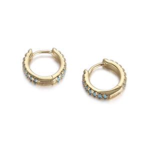 Detail of gold huggie hoop earrings featuring continuous blue enamel dot accents