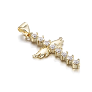 Macro view of 14k gold plated cross pendant with angel wings and white cubic zirconia