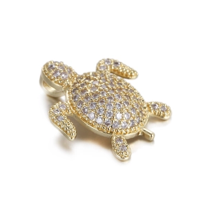 Detailed view of turtle pendant with micro-pave zircons and 14k gold plated finish