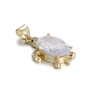 Detailed macro view of the turtle pendant with large clear stone and zircon inlay