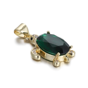 Detailed view of turtle pendant with green oval gemstone and micro-set cubic zirconia