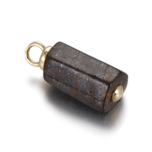 Macro view of a hexagonal natural brown stone pendant with golden metal caps and ring