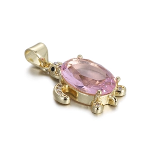 Detail of 14k gold plated turtle pendant with pink gemstone and micro-set zircons