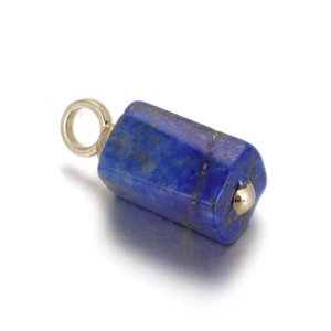 Macro shot of natural lapis lazuli cylinder pendant with gold loop for DIY jewelry