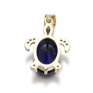 Detailed view of turtle pendant with blue faceted gemstone and 14k gold finish metal