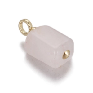 Detailed macro of a rectangular rose quartz pendant with a polished gold metal clasp