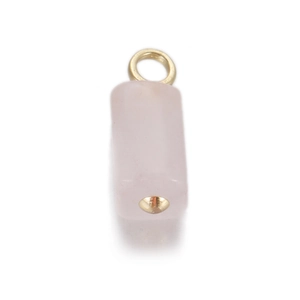 Macro detail of rectangular pink quartz pendant with gold loop and rivet on white background
