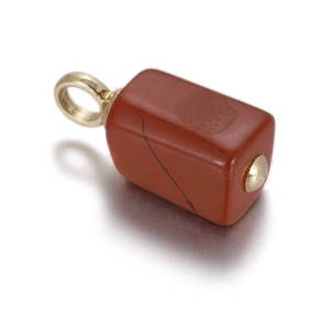 Macro shot of rectangular red jasper stone pendant with gold metal bail on white surface