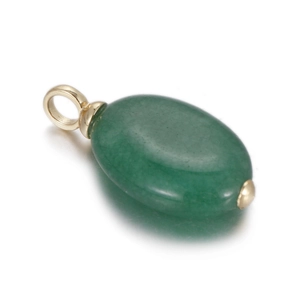 Macro shot of oval green natural stone pendant with golden metal clasp and smooth finish