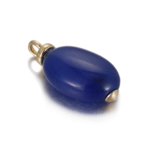 Macro shot of dark blue oval semi-precious stone pendant with gold metal accents