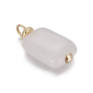 Macro detail of rectangle white natural stone pendant with golden metal findings