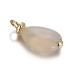 Macro shot of milky white chalcedony teardrop pendant with gold metal findings for DIY necklaces
