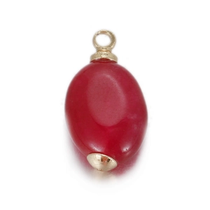 Macro view of red oval stone pendant with polished gold-plated metal clips for jewelry making