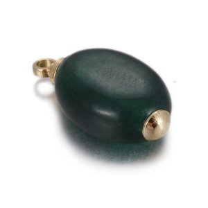 Macro shot of dark green gemstone pendant with polished gold metal caps and loop