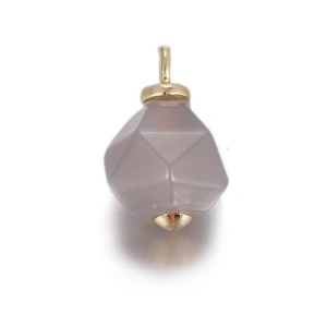 Macro view of geometric gray faceted stone pendant with elegant gold plated findings