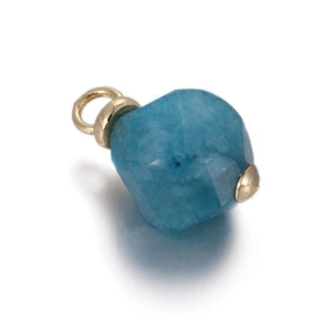 Detailed view of a faceted blue natural stone pendant with a polished gold bail for DIY jewelry