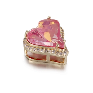 Macro view of a 14k gold-plated pink heart gemstone pendant with a sparkling zircon halo
