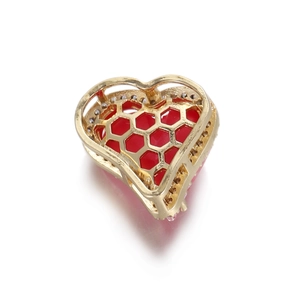Macro shot of 14k gold-plated heart pendant with red enamel and white rhinestone accents