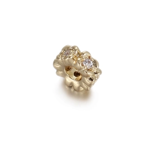 Detailed macro view of 14k gold plated flower coin spacer bead with cubic zirconia accents