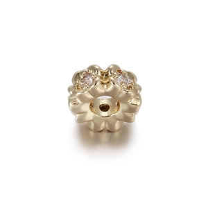 Macro detail of 14k gold plated flower bead with cubic zirconia for jewelry making