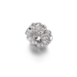 Macro detail of silver flower bead with cubic zirconia for DIY jewelry making