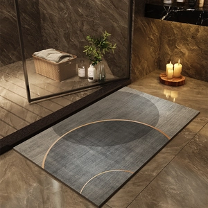 Absorbent diatom mud bath mat with minimalist geometric rings on dark marble floor
