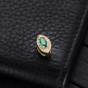 14k gold-filled marquise emerald zircon flower charm on black leather background