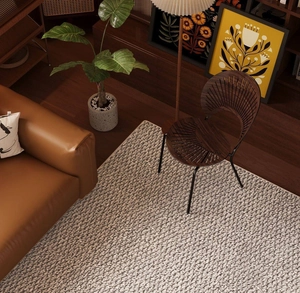 Close-up of modern gray sisal-style woven carpet texture on dark wood floor