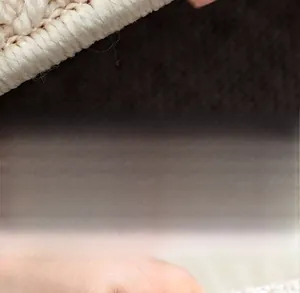 Detailed macro view of cream woven kitchen mat texture showing soft skin-friendly fabric