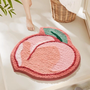 Détail du tapis épais en forme de pêche avec dégradé de rose et feuille verte douce