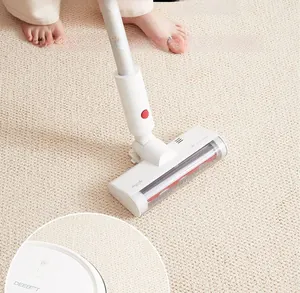 Close-up of a brush head vacuuming a sisal style kitchen rug on a light carpet