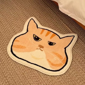 Detail of funny orange cat faux cashmere rug with non-slip texture for bedroom floor