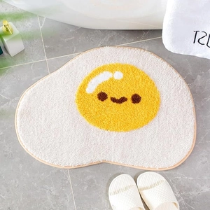Cute cartoon fried egg bath mat with a smiling face on a soft microfiber rug surface