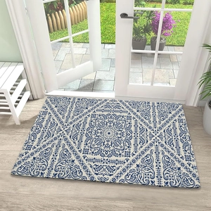 Detail of bohemian mandala diatom mud mat on light wood floor by a French door